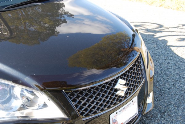 The hood deflector on a black car is rather subtle. The spots on my hood are not paint chips. My car is just dirty. You can also see the clear bumpons under the corners of the hood deflector. They keep the deflector from touching the hood under wind resistance.