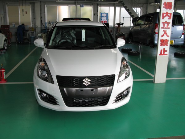 Suzuki Swift Sport. Distinguishable by the aggressive bumper and fascia around the fog lights.