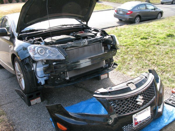 Remove the bumper and the headlights to have full access to the adjuster cover. Access to the rear of the headlights is key.