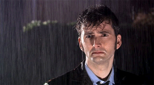 Man in the rain looking sad.gif